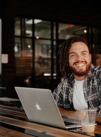 Homem com notebook sorrindo